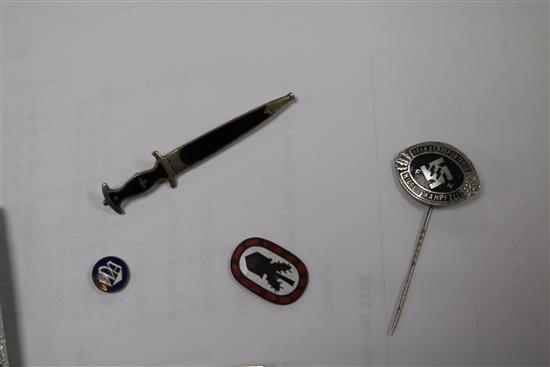 A German Iron Cross 1st class, an SS lapel badge number 792, dagger lapel pin, German army belt buckle, three German badges without pin